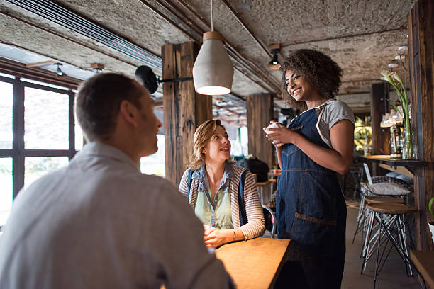 istock Waitress serving customers at a restaurant 612505210