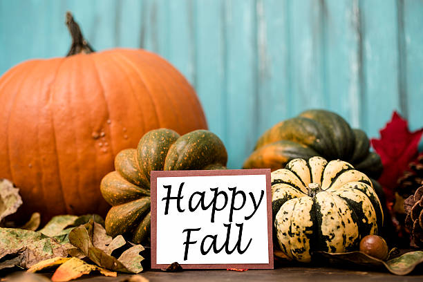 istock Happy Fall!  Autumn centerpiece with orange pumpkin, leaf decorations. 612505286