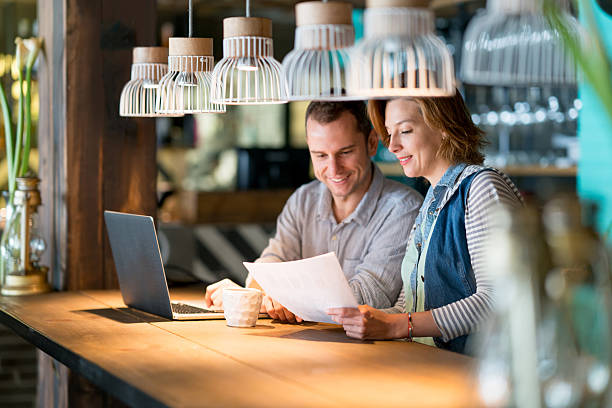 istock Couple of people working at a cafe 612505602