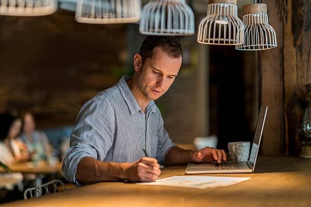 istock Man doing the books at a restaurant 612505724