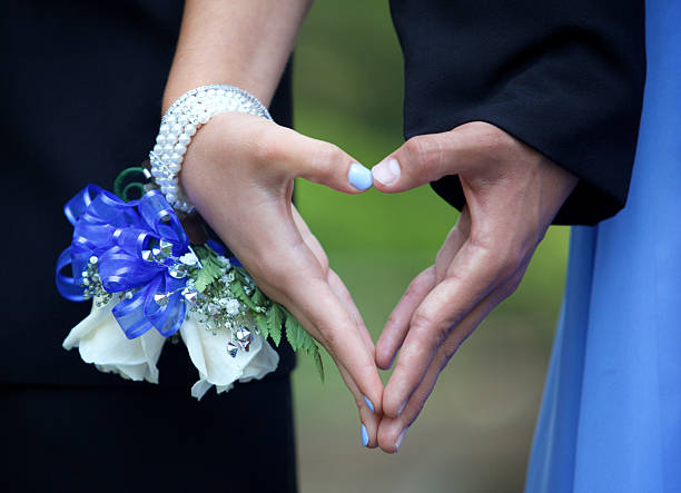 Prom Couple Forming a Heart with their Hands  Close Up