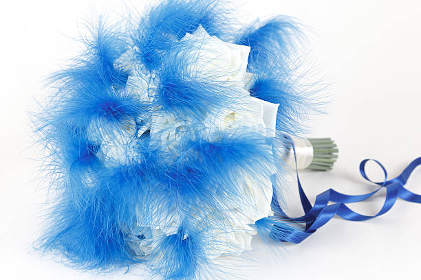 istock White roses and blue feathers bridal bouquet 612508148