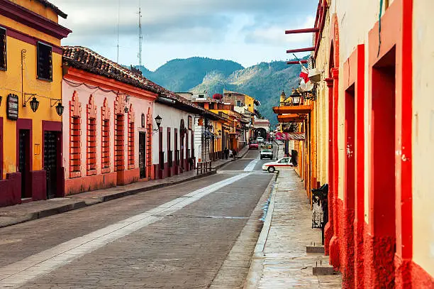 Streets in the cultural capital of Chiapas - San Cristobal de las Casas, Mexico. The city center maintains its Spanish colonial layout and much of its architecture. Mountains at the background