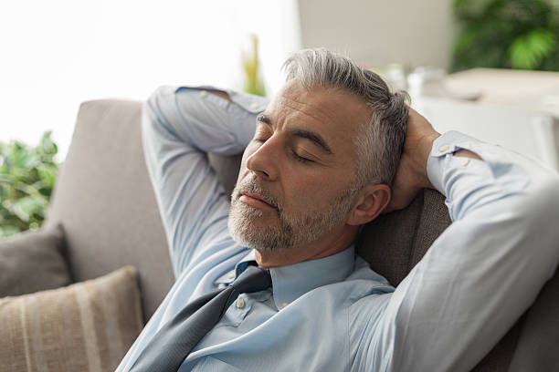 istock Businessman sleeping on the couch 612508824