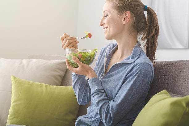 istock Young woman having lunch at home 612509188