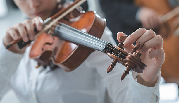 istock Violinist tuning a violin 612511704