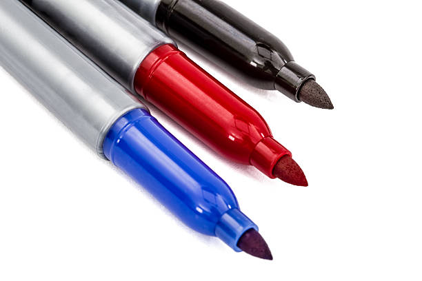 istock Three felt-tip pens markers highlighters close-up, isolated on w 612513290