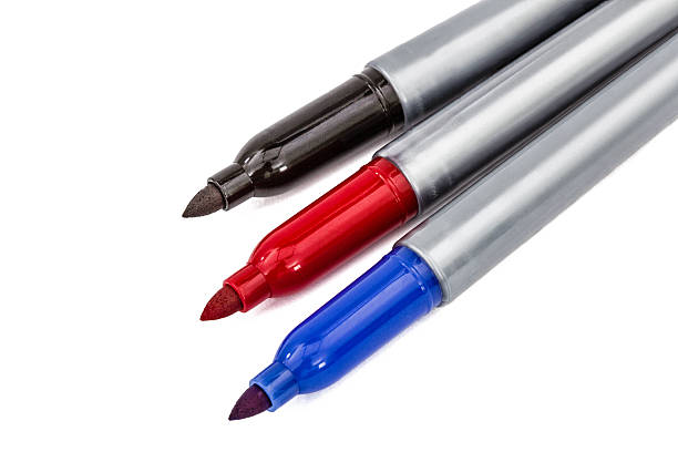 istock Three felt-tip pens markers highlighters close-up, isolated on w 612513374