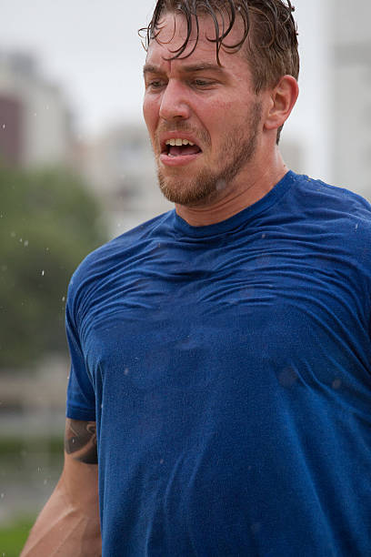 Nerd athlete tries to take a drink of water but misses and sprays himself in the face