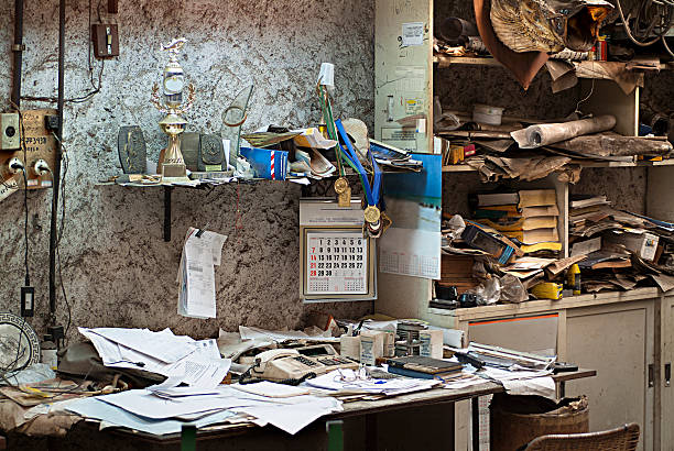 oficina sucia y abandonada con libros y papeles - cluttered desk fotografías e imágenes de stock