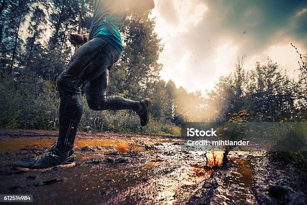 Runner Stock Photo - Download Image Now - Running, Mud, Cross-Country Running