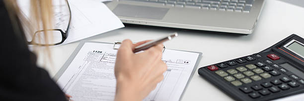 Close up shot of woman hand filling tax form Close up shot of woman hand filling tax form. Savings, finances and economy concept. Letter box format Bureaucracy stock pictures, royalty-free photos & images