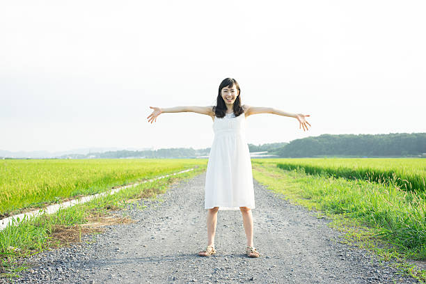 istock Woman standing in a rice paddy 612516768