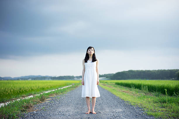 istock Woman standing in a rice paddy 612516832