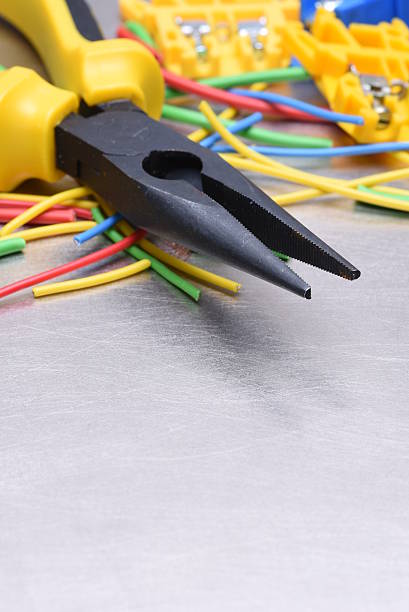 istock Tools for electrician and cables on metal surface 612516884
