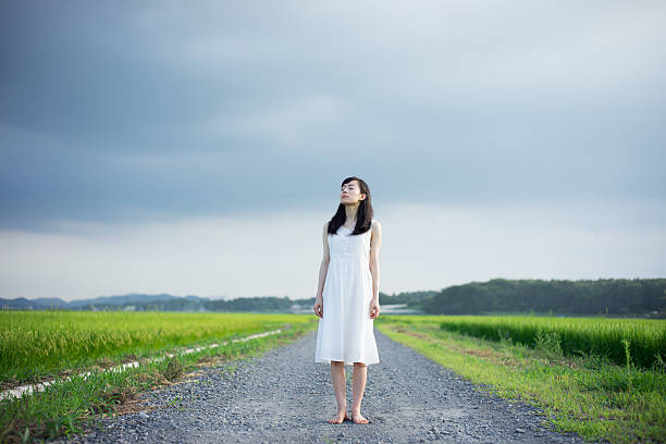istock Woman standing in a rice paddy 612516898