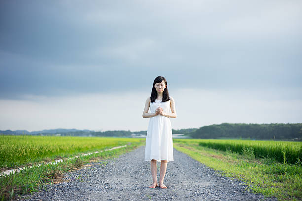 istock Woman standing in a rice paddy 612516988