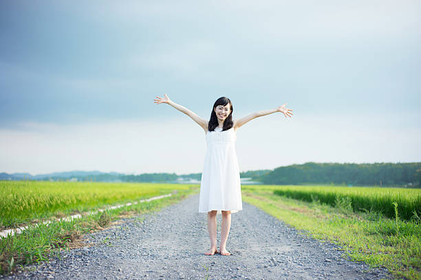 istock Woman standing in a rice paddy 612517064