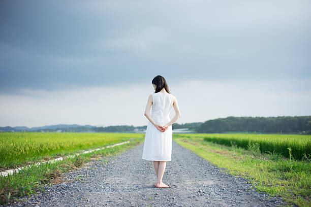 istock Woman standing in a rice paddy 612517138