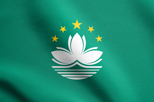 Macanese official flag. Patriotic chinese symbol, banner, element, background. Macau is special region of PRC. Flag of Macau waving in the wind with detailed fabric texture