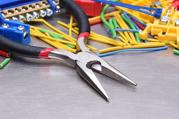 istock Tools for electrician and cables on metal surface 612517246