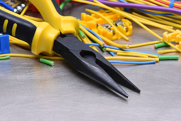istock Tools for electrician and cables on metal surface 612517422