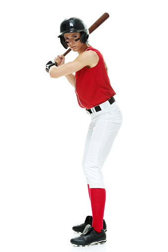 Female baseball player batting