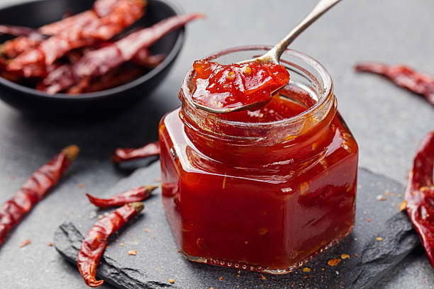 Tomato and chili sauce, jam, confiture in a glass jar stock photo