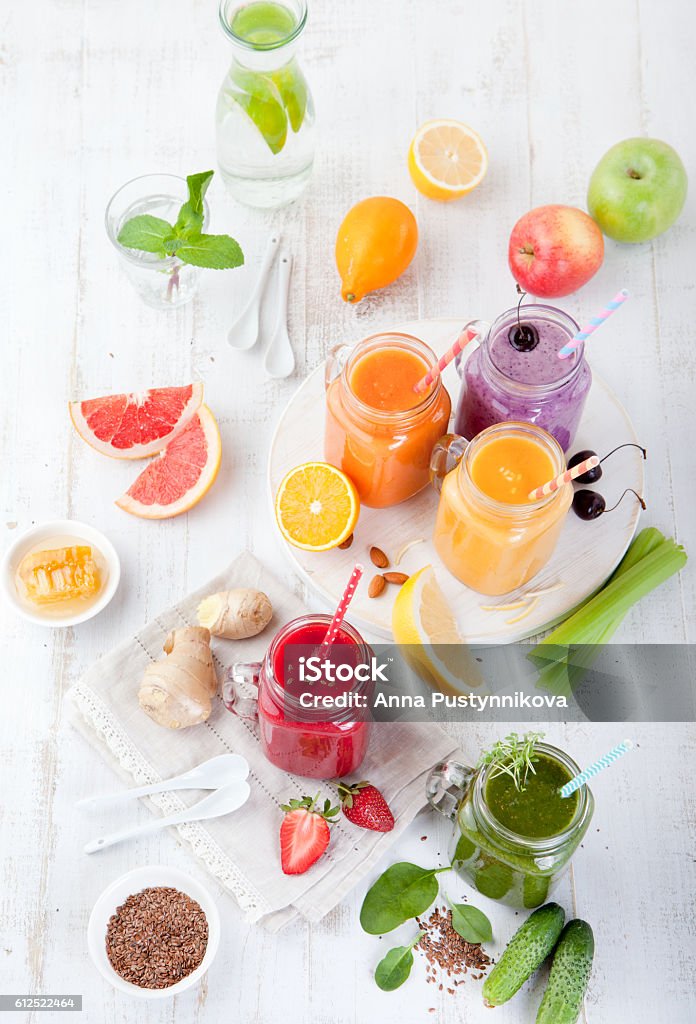 Smoothies, juices, beverages, drinks variety Smoothies, juices, beverages, drinks variety with fresh fruits and berries on a white wooden background. Top view. Smoothie Stock Photo