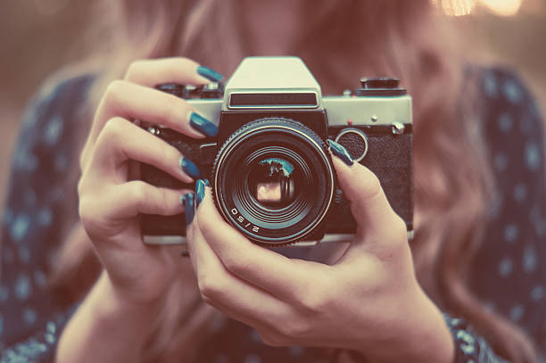 istock Vintage camera in girl's hands 612523366
