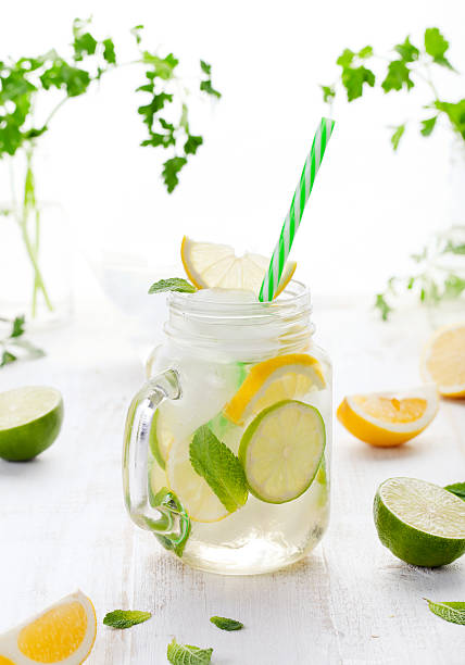 istock Lemonade with ice, lemon and lime slices in jar 612523508