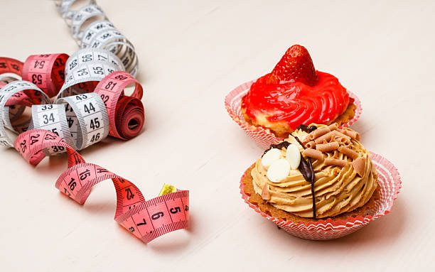 istock cupcakes with measuring tape on table 612524262