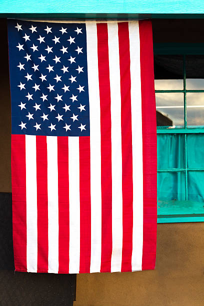 US Flag Hangs Near Old Turquoise Window