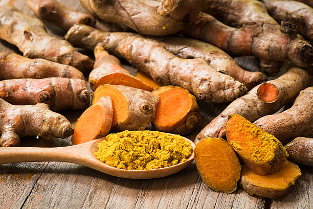 istock Prepared fresh turmeric roots with turmeric powder 612525266