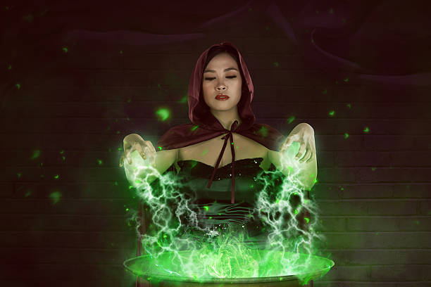 istock Asian girl witch with red cloak preparing a magic potion 612614582