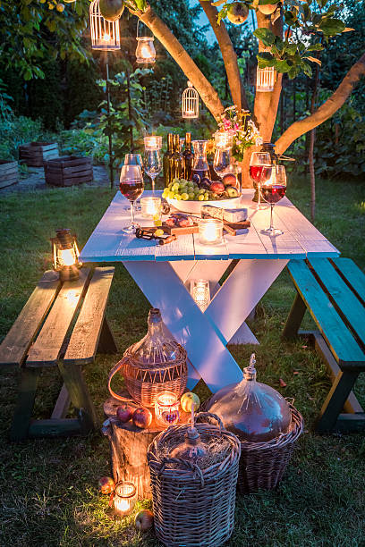 istock Gorgeous table with wine and candles in garden at dusk 612614658