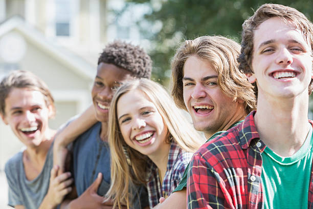 istock Group of five multi-ethnic teenagers hanging out 612615946