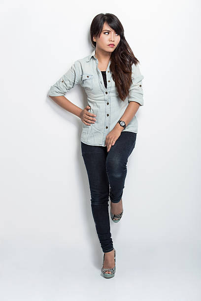 istock Young asian woman standing and leaning on white background 612616440