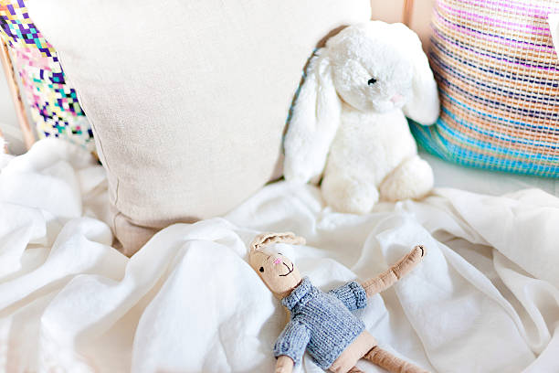 istock Rabbit toys on a bed with pillows closeup 612617008