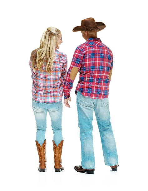 istock Rear view cowboy couple standing 612617086