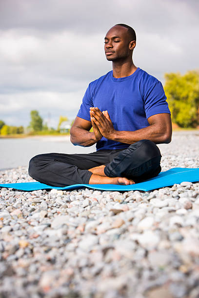 istock young man exercising yoga 612618316