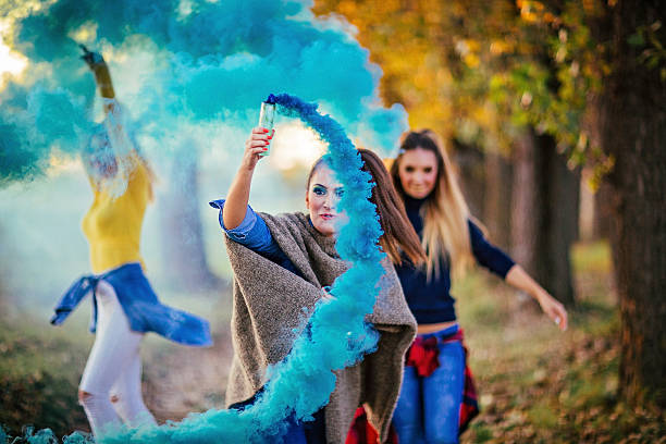 istock Girls in blue smoke 612619262