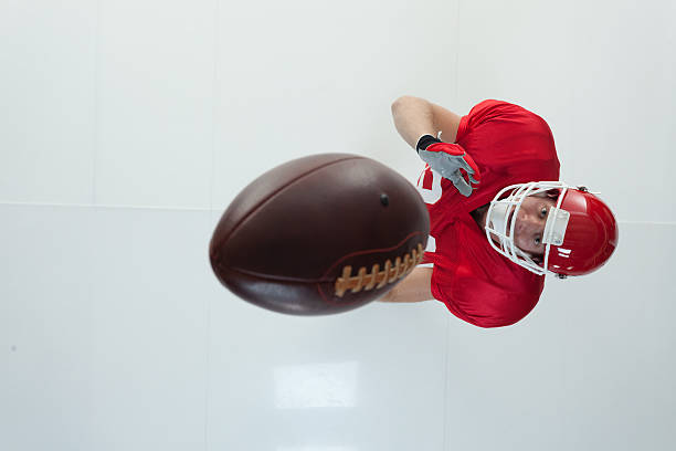 istock American football player throwing a ball 612620704