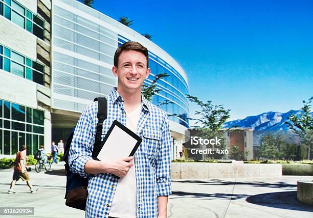 Smiling Student Standing At The Campus Stock Photo - Download Image Now - Brigham Young University, 20-29 Years, 25-29 Years