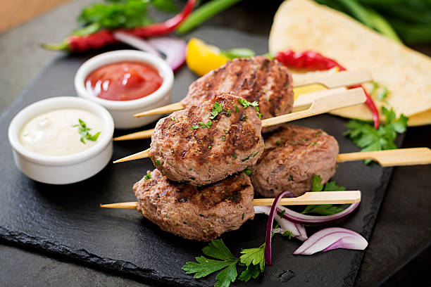 istock Appetizing kofta kebab (meatballs) with sauce and tortillas tacos 612623106