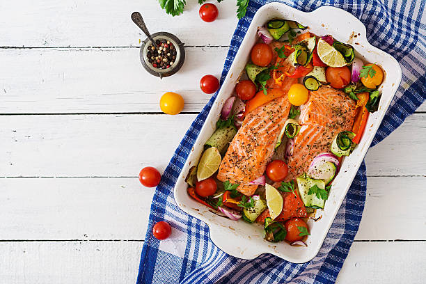 istock Baked salmon fillet with vegetables. Top view 612623656
