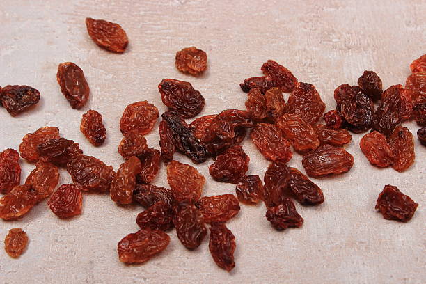 istock Brown raisins on structure of concrete, healthy eating 612624836