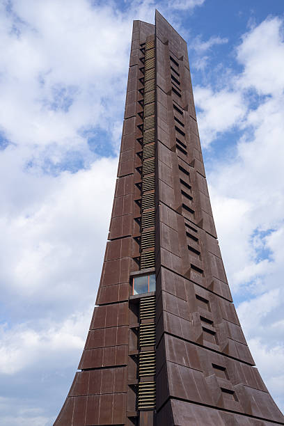 Low angle view of the clock tower on campus of Daejeon Institute of Science and Technology on a sunny blue sky day in South Korea. Horizontal