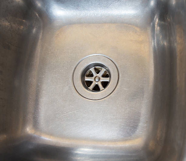 Stainless steel drain in kitchen sink stock photo