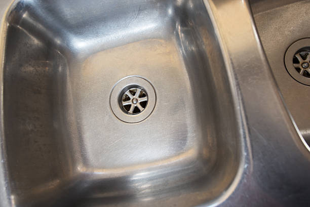 Stainless steel drain in kitchen sink stock photo